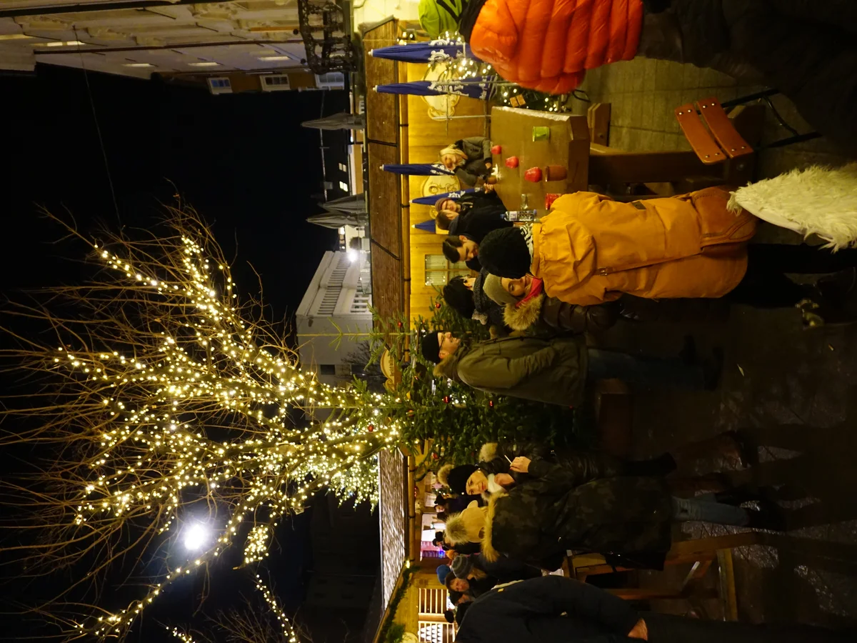 Innsbruck blue-hour Christmas market scene with illuminated tree