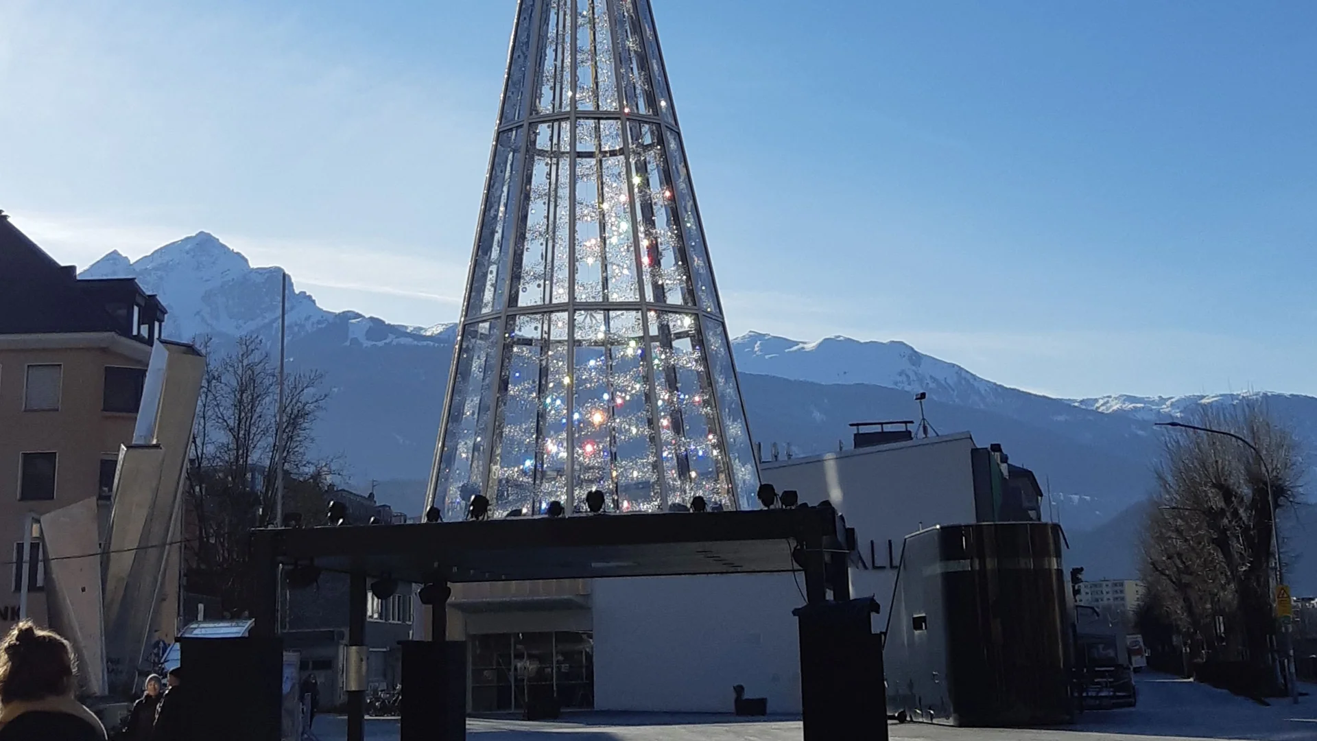 Innsbruck illuminated artificial Christmas tree in winter against Alpine peaks