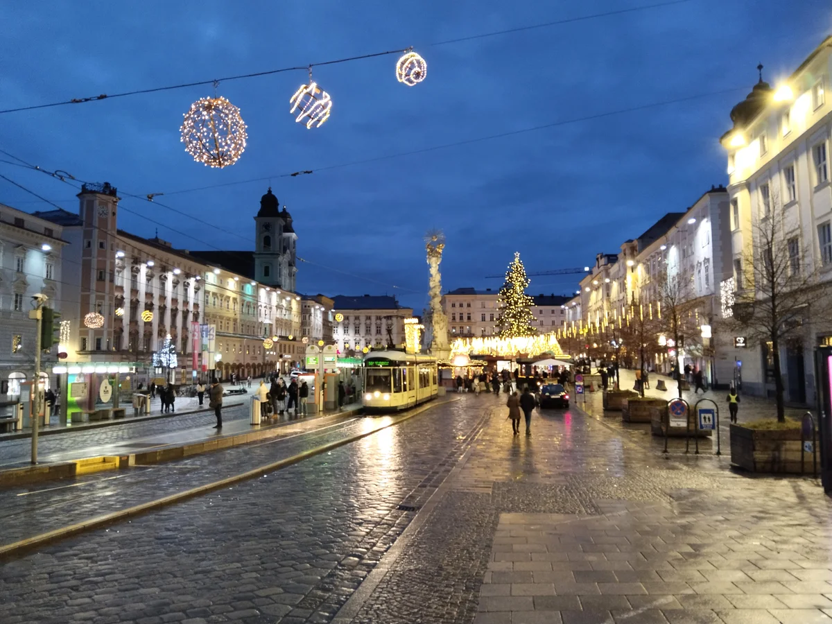 Linz Hauptplatz adorned with Christmas lights and decorations during winter dusk