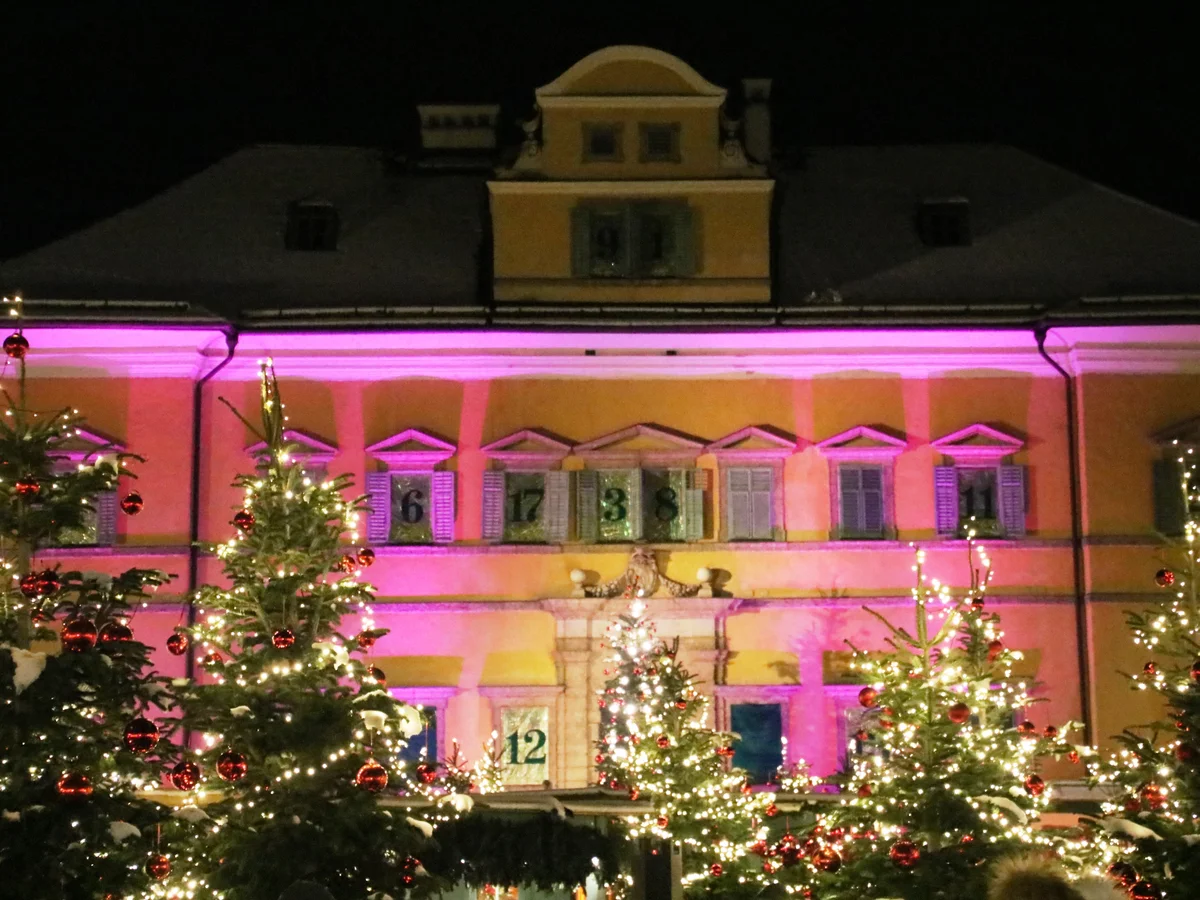 Salzburg Hellbrunn Palace illuminated in pink during festive Christmas season