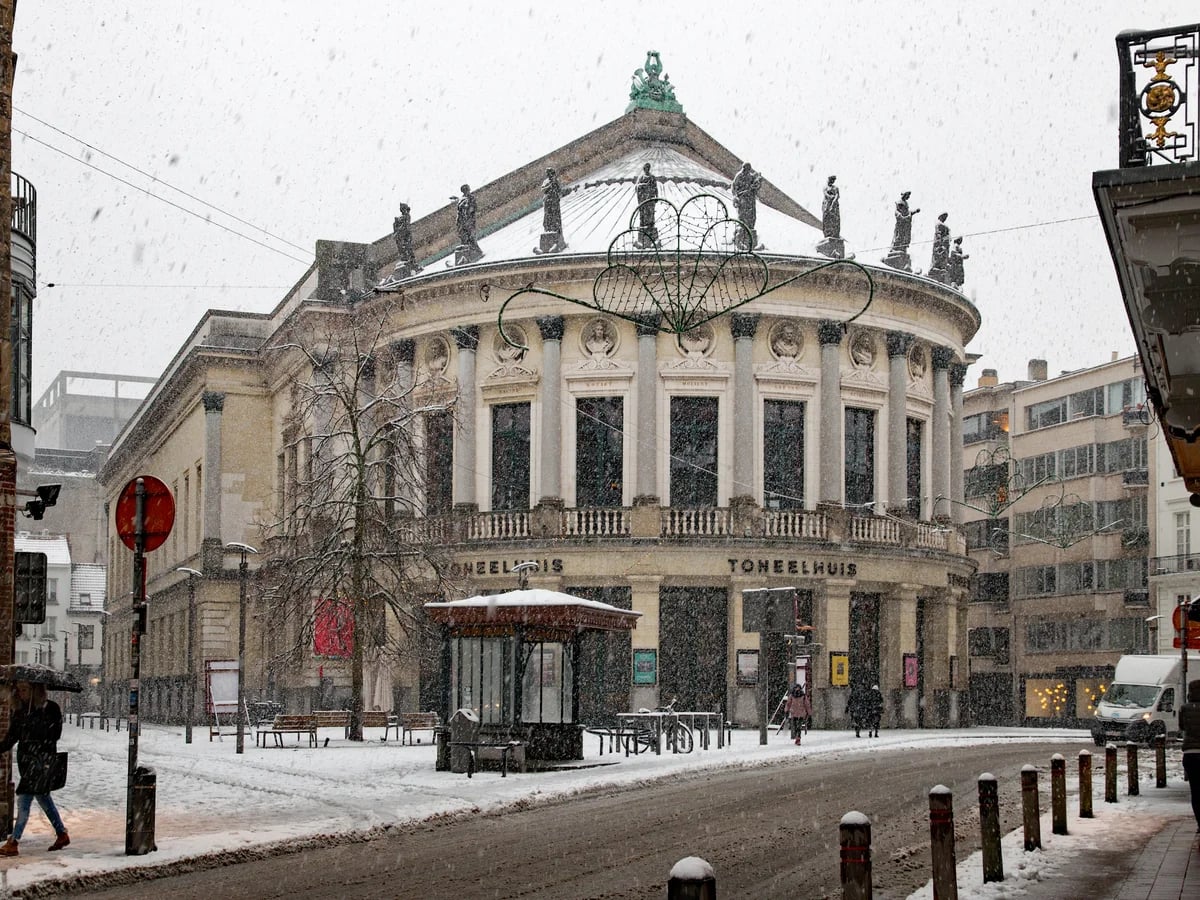 Antwerp Bourla Theatre in heavy snowfall showcasing a magical winter atmosphere