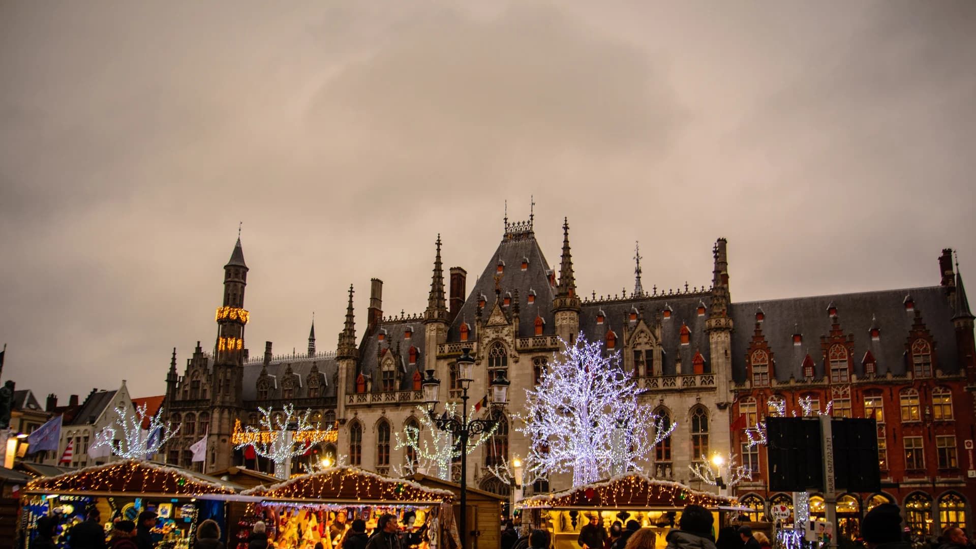 Bruges Christmas market with Belfry tower and festive atmosphere