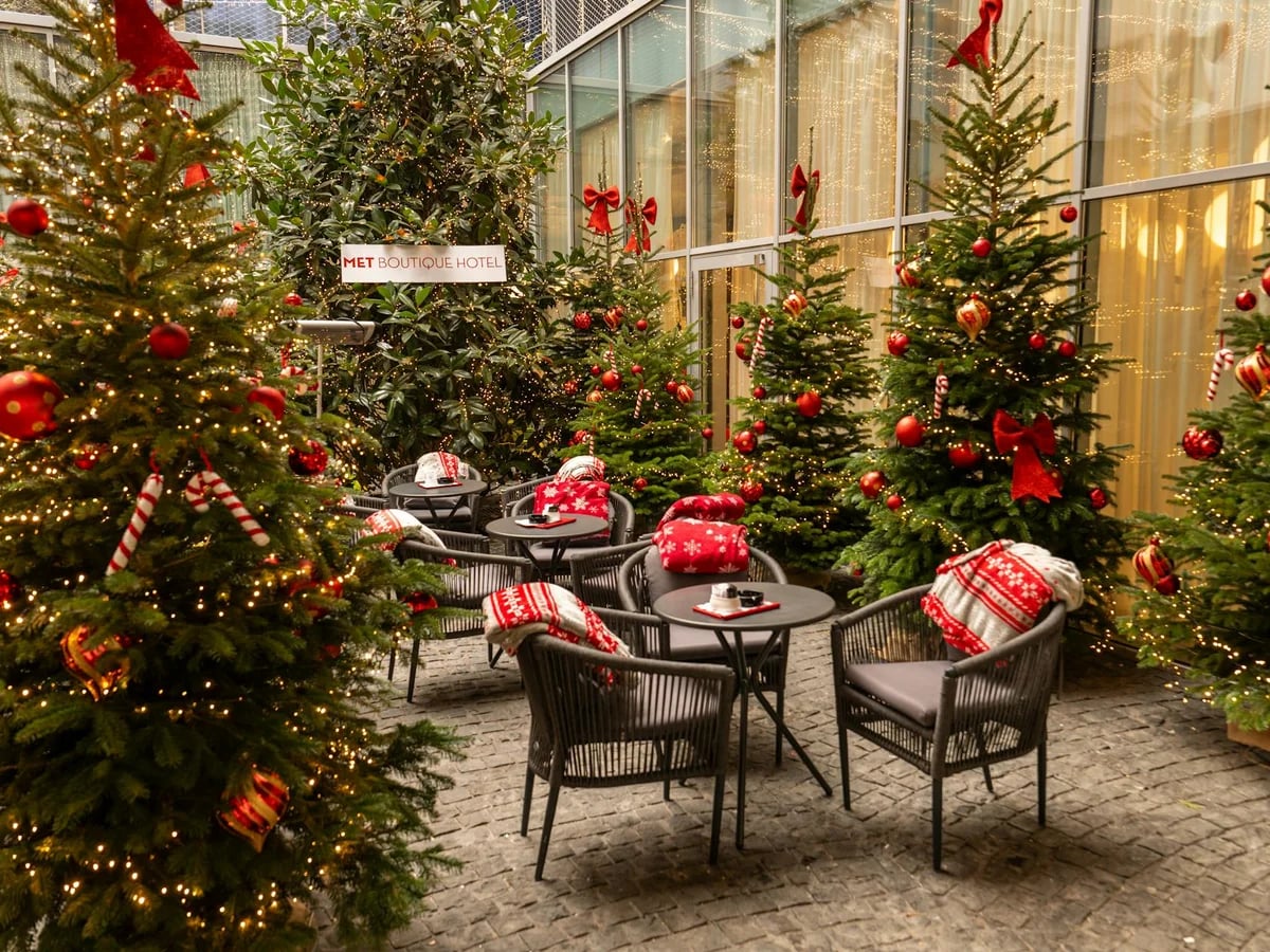 Zagreb beautifully decorated hotel courtyard with Christmas trees and warm lights