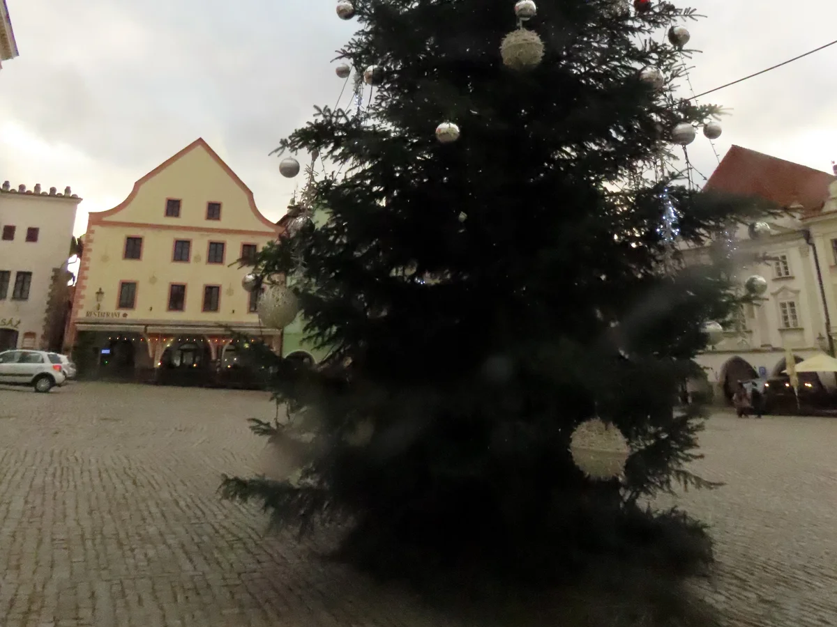 Český Krumlov Christmas market square with festive tree in winter