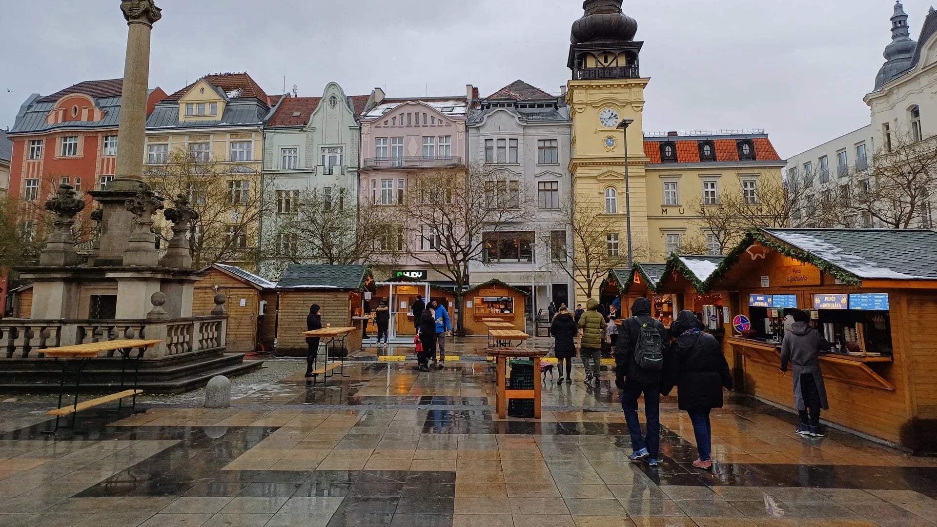Ostrava's iconic clock tower and wooden stalls at a festive Christmas market