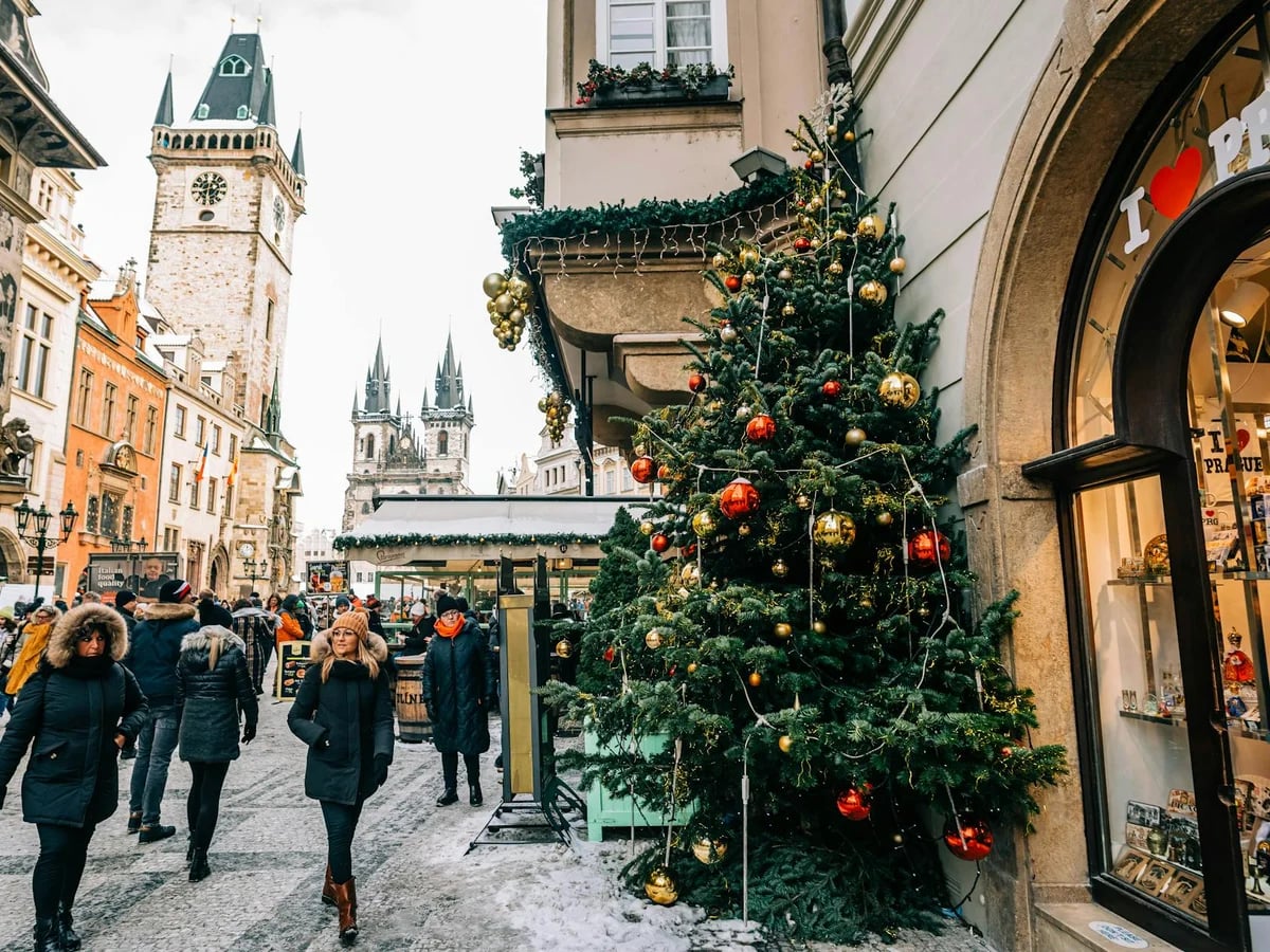Prague festive market scene with Church of Our Lady before Tyn during Christmas season