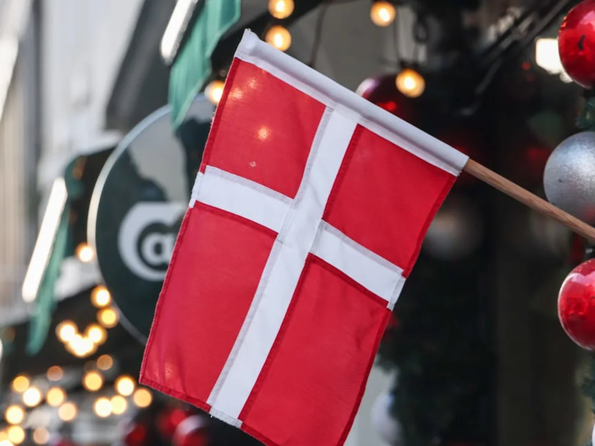 Copenhagen Danish flag adorned with festive ornaments and warm lights during Christmas season