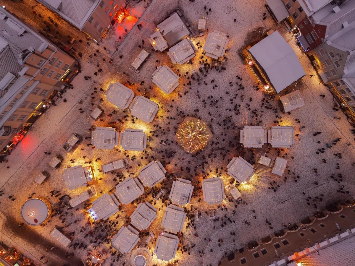 Tallinn Christmas market at golden hour showcasing medieval architecture