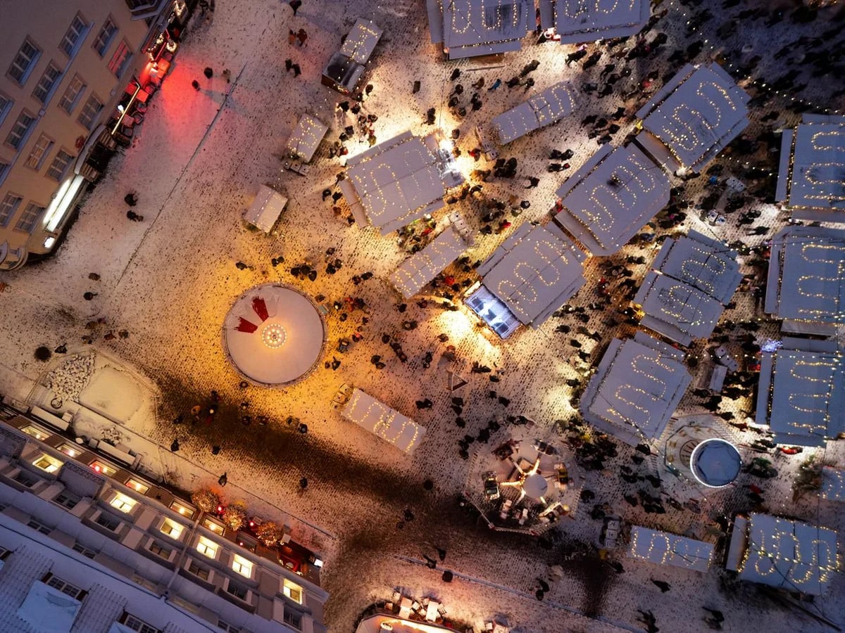 Tallinn's enchanting Christmas market at twilight with glowing stalls