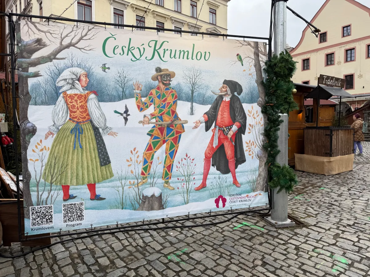 Festive decorations and lights at an Unknown Christmas market in Český Krumlov, showcasing Czech folk art.