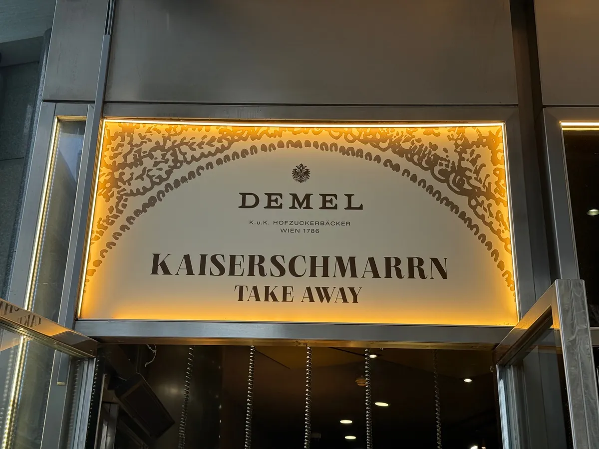 Festive decorations and lights at an unknown Christmas market, featuring a beautifully illuminated sign.