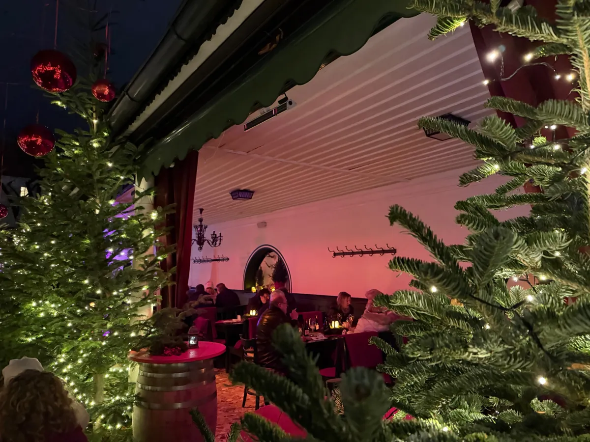 Unknown Christmas market featuring festive decorations and vibrant lights in a modern city setting.