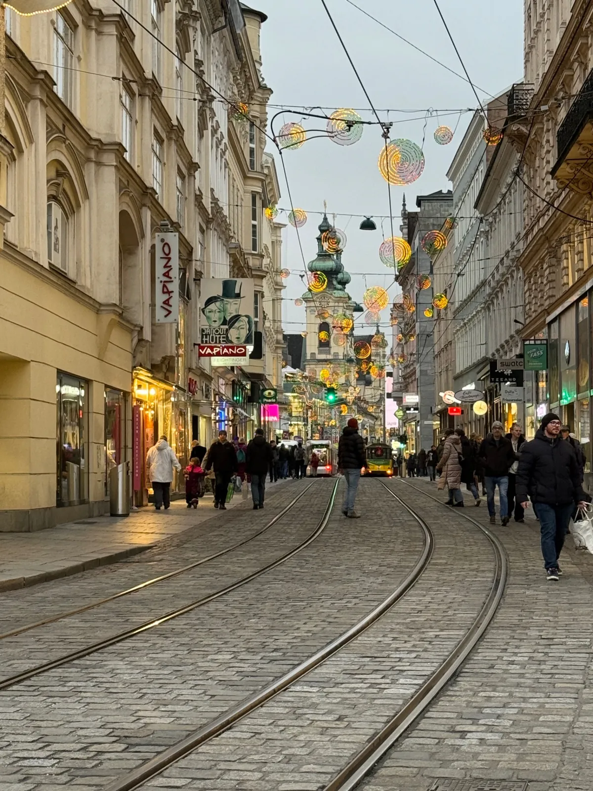 Charming European street scene with festive decorations and lights at an Unknown Christmas market.