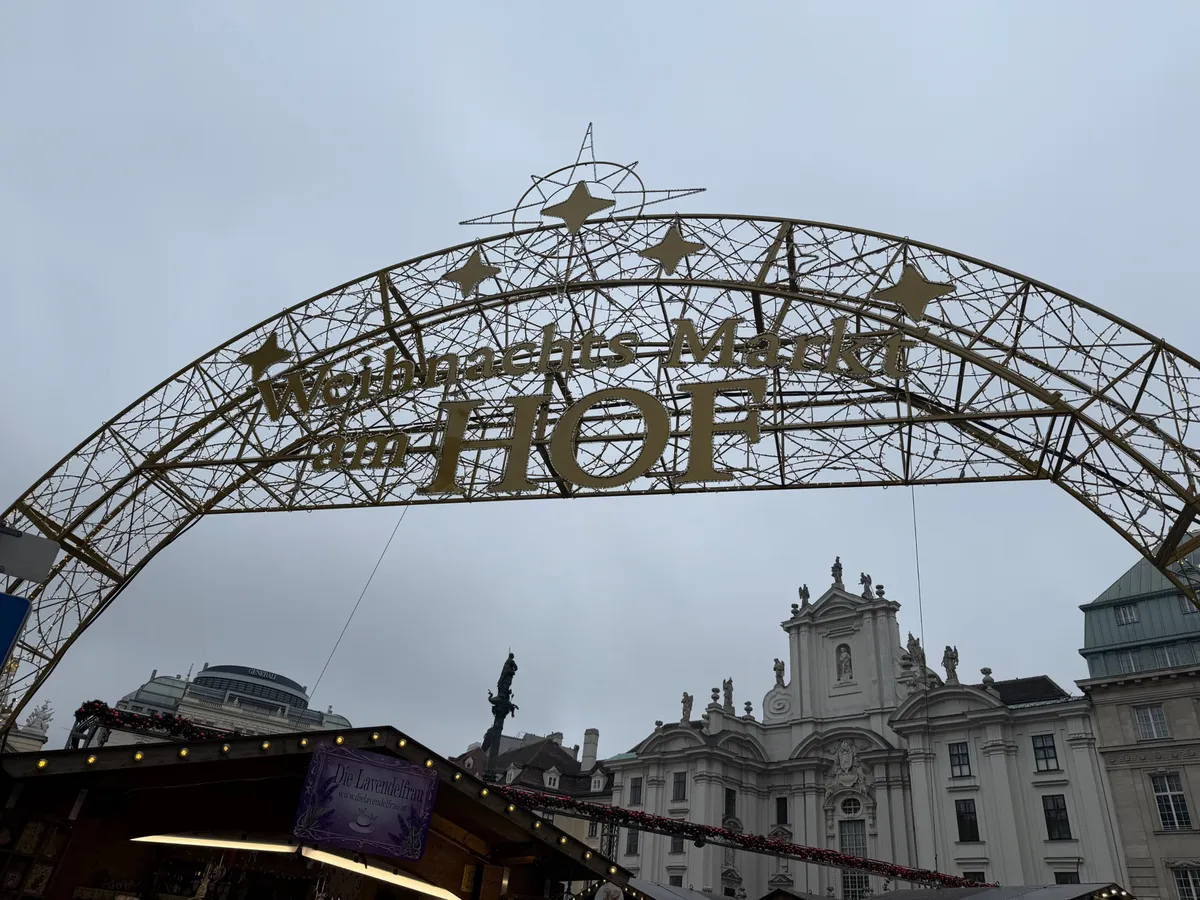 Festive decorations and lights at an Unknown Christmas market with an ornate archway.