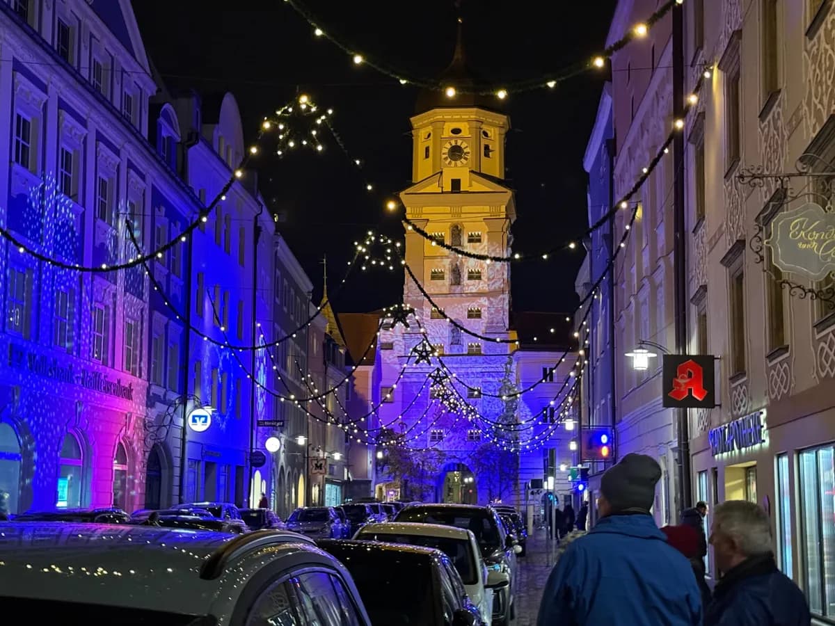 Beautifully illuminated Unknown Christmas market with festive decorations and lights on a city street.