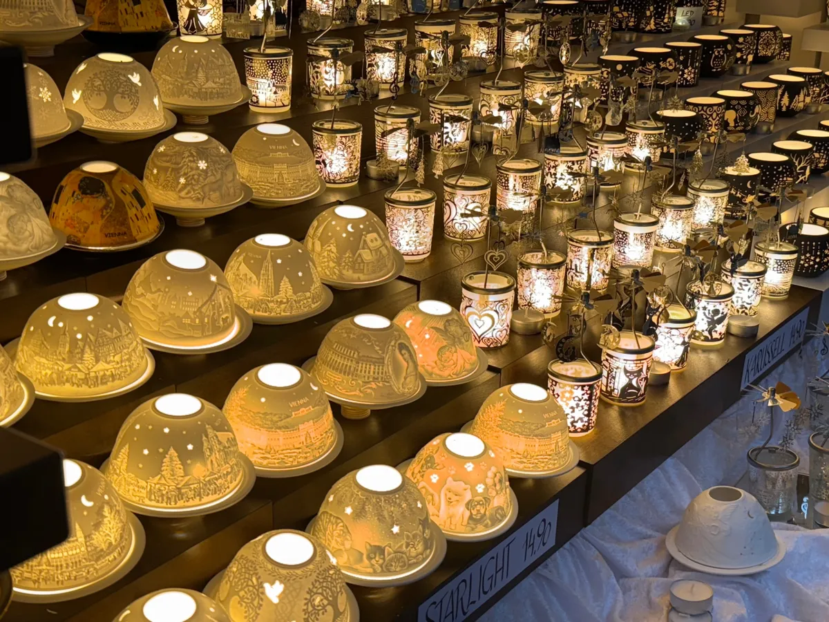 Festive decorations with beautiful lights at an Unknown Christmas market featuring intricate porcelain lanterns.