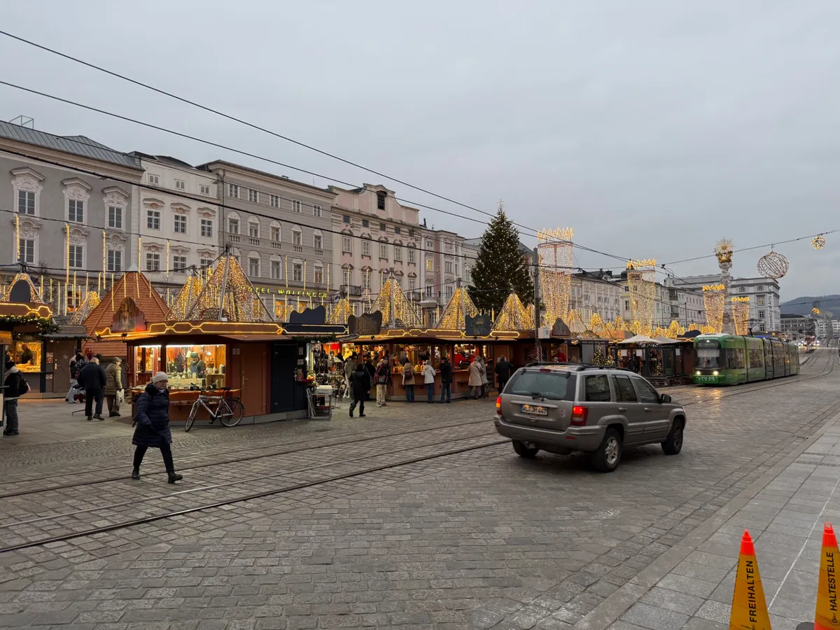Sprawling Unknown Christmas market featuring festive decorations and golden lights, showcasing traditional wooden stalls.