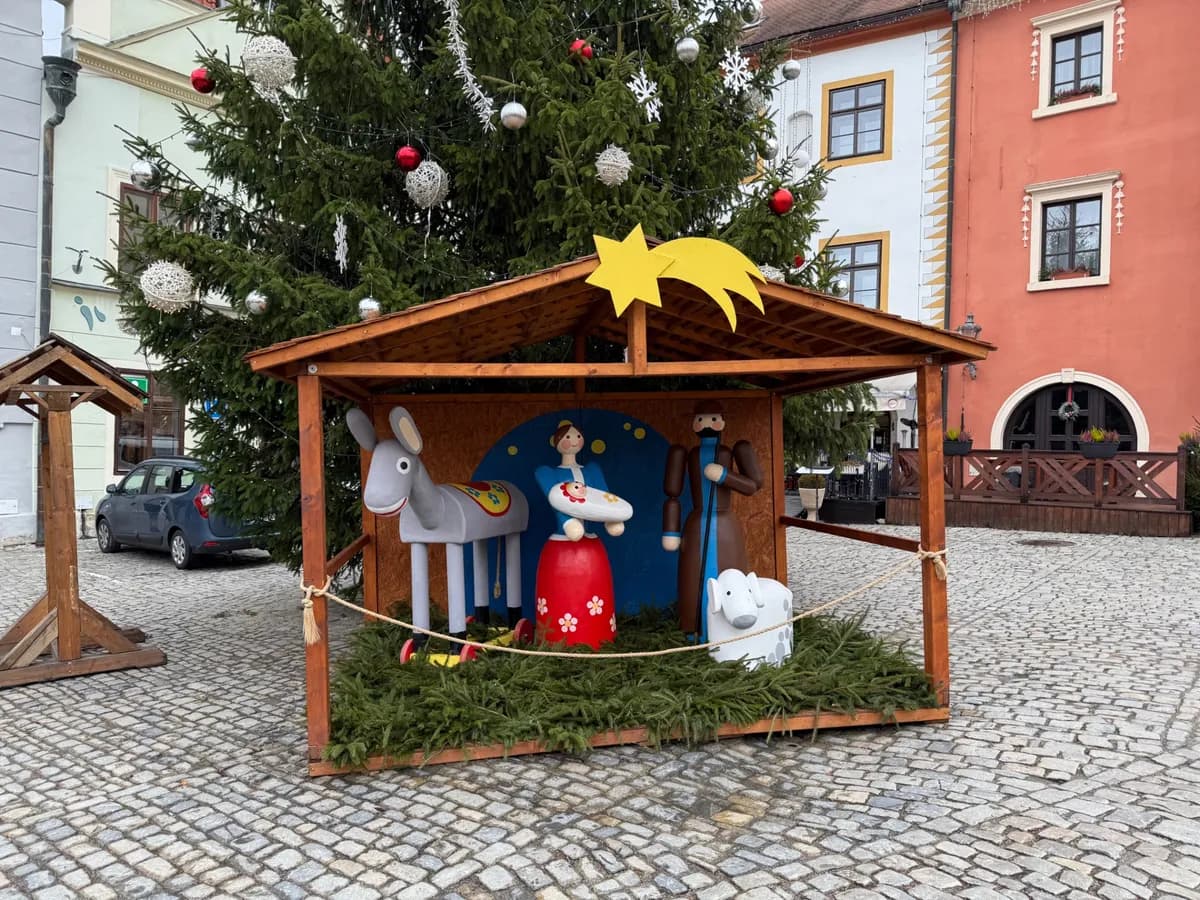 Whimsical nativity scene with festive decorations at an Unknown Christmas market, showcasing vibrant lights and holiday charm.