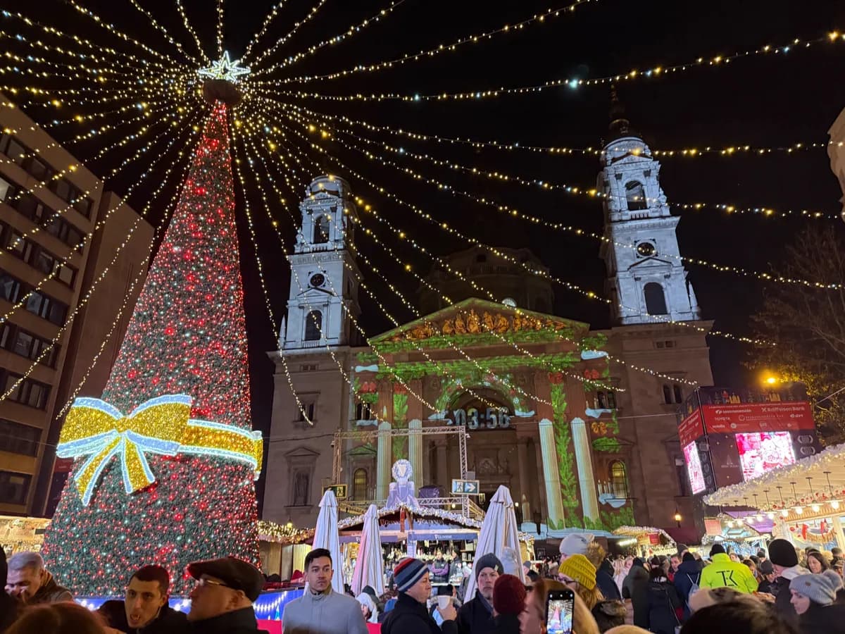 Breathtaking view of an Unknown Christmas market with festive decorations, lights, and a vibrant red tree.