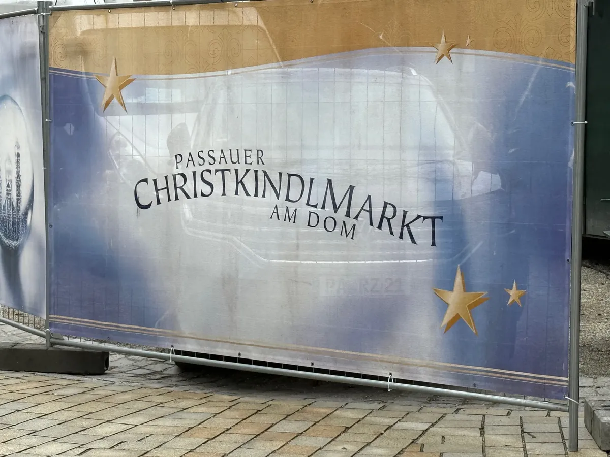 Unknown Christmas market signage in Passau, showcasing festive decorations and lights for the holiday season.