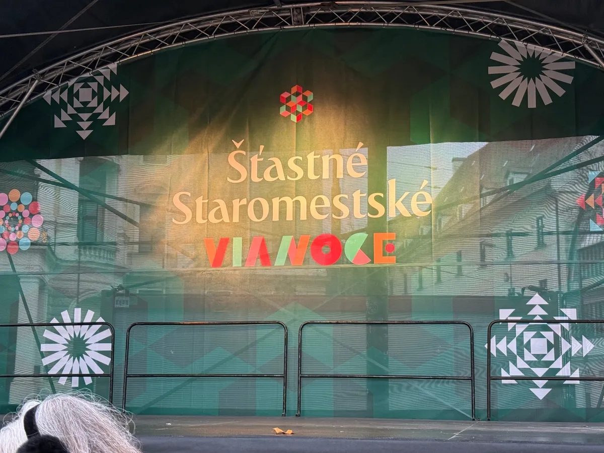 Unknown festive decorations with geometric designs and lights at a modern event space resembling a Christmas market.