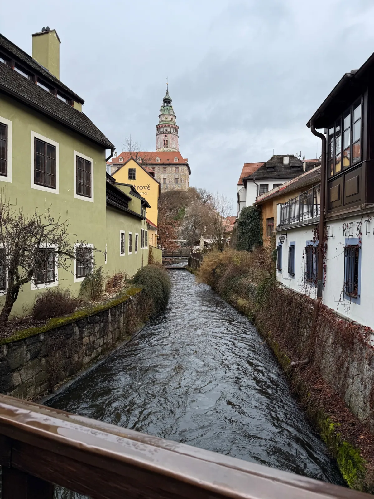 Charming medieval town with canals and historic buildings, lacking festive decorations and lights for a Christmas market.