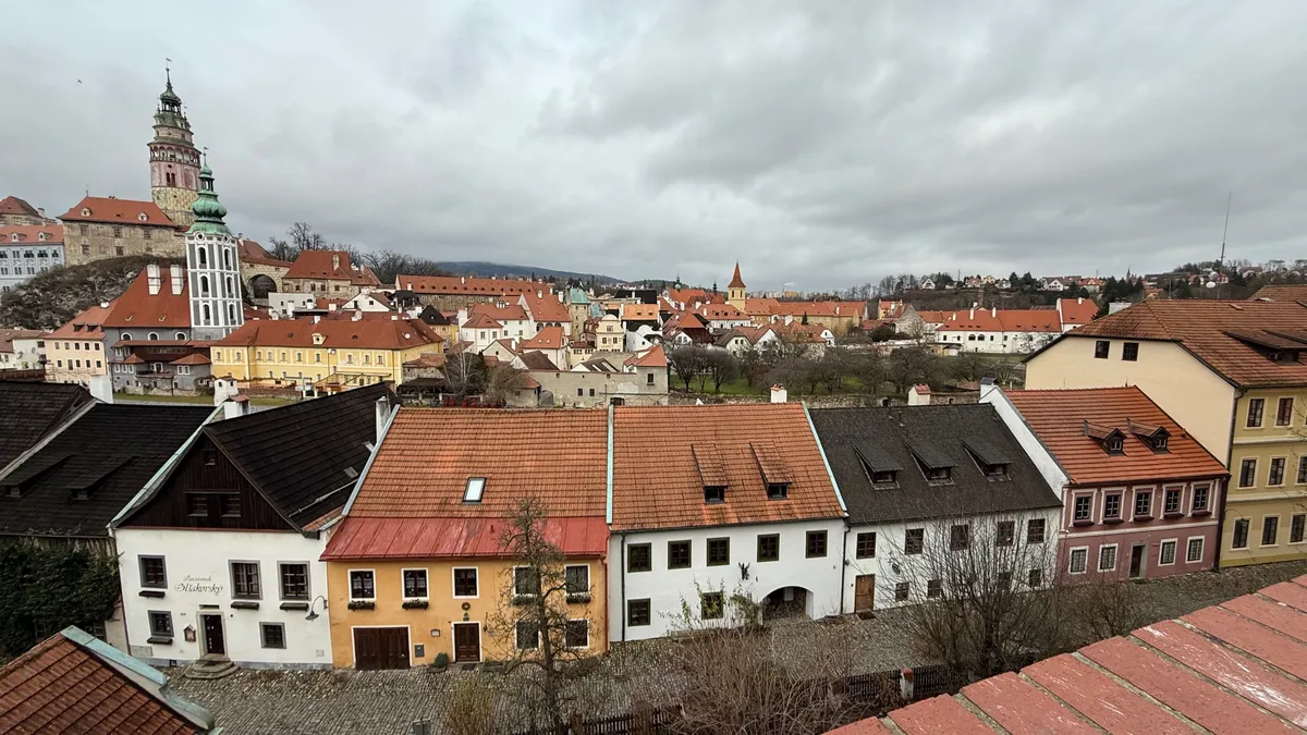 Overcast cityscape of an Unknown European town with traditional architecture, lacking festive decorations and Christmas market lights.