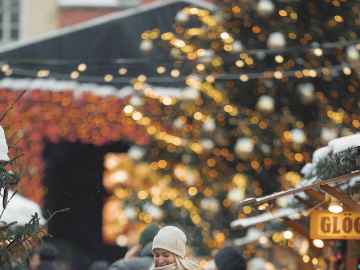 Turku Christmas market with golden bokeh lights and joyful visitors in winter