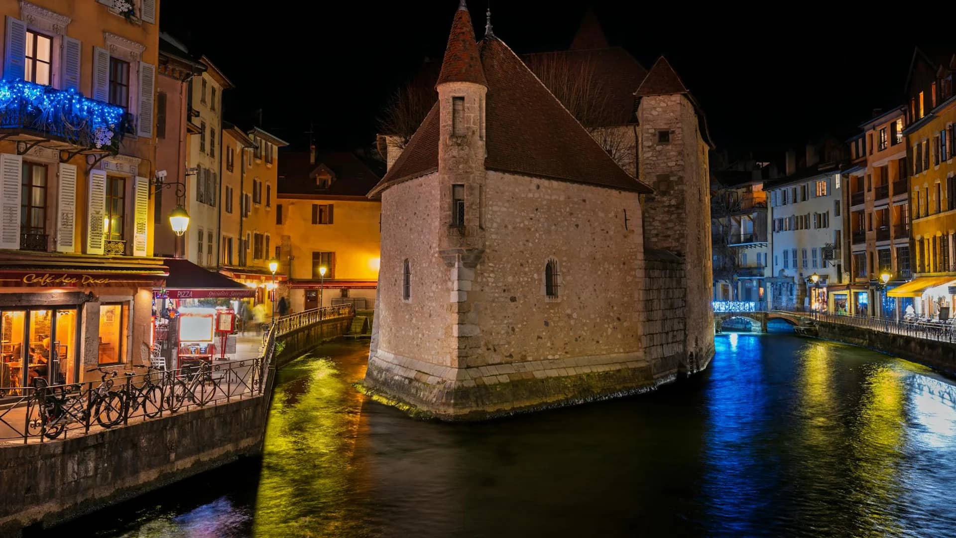 Annecy Palais de l'Isle illuminated at night during Christmas season