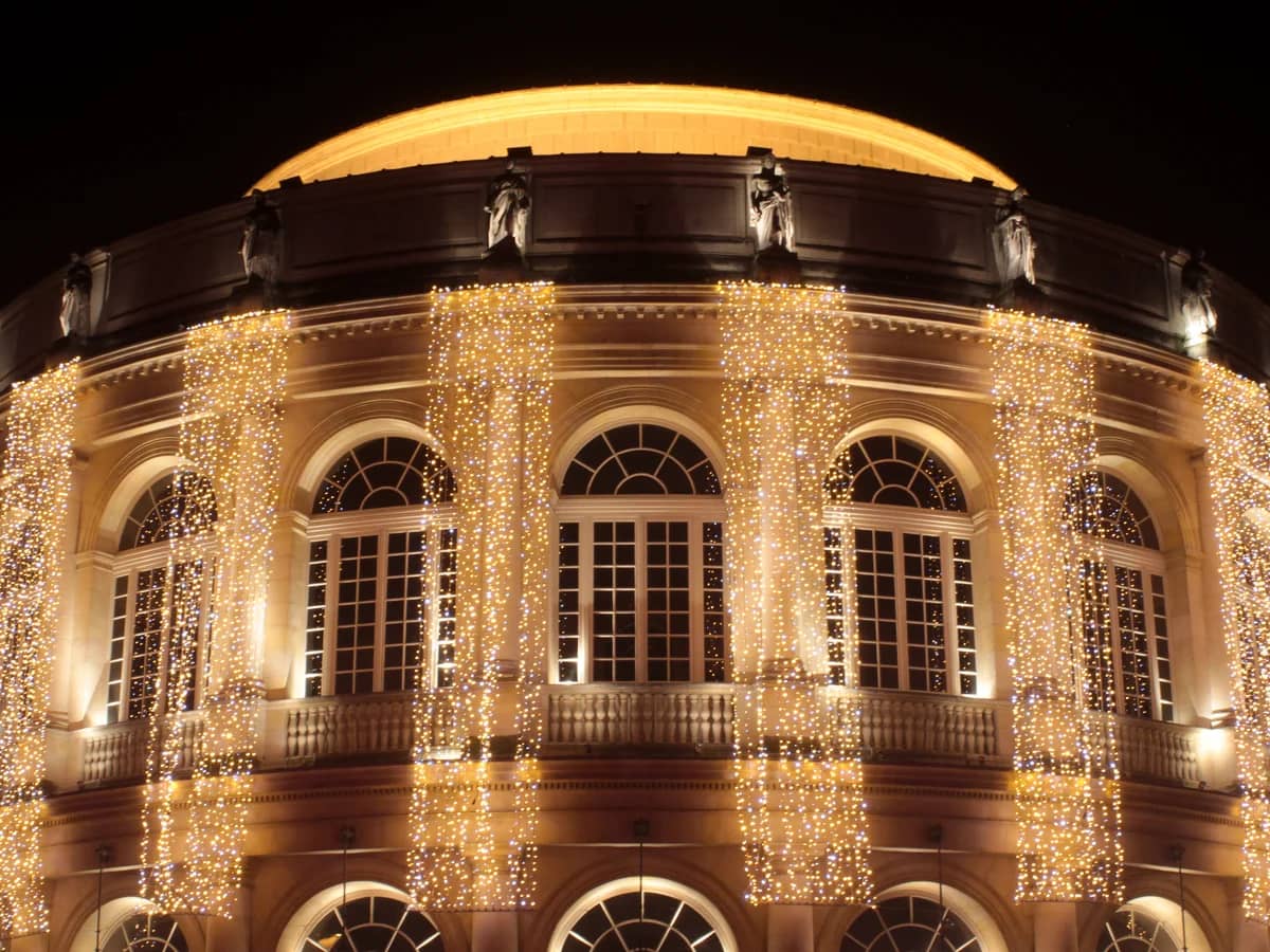 Rennes Opera House adorned with golden Christmas lights in winter night