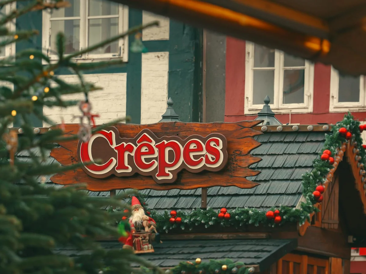Ribeauville festive crêpes stall adorned with holiday garlands in a cozy winter setting