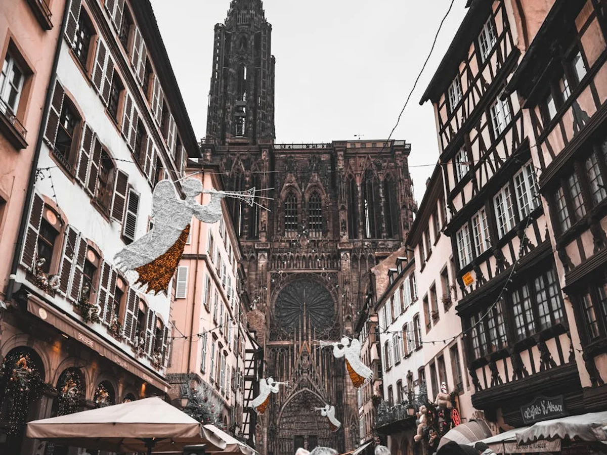 Strasbourg Cathedral framed by festive decorations in a winter Christmas market