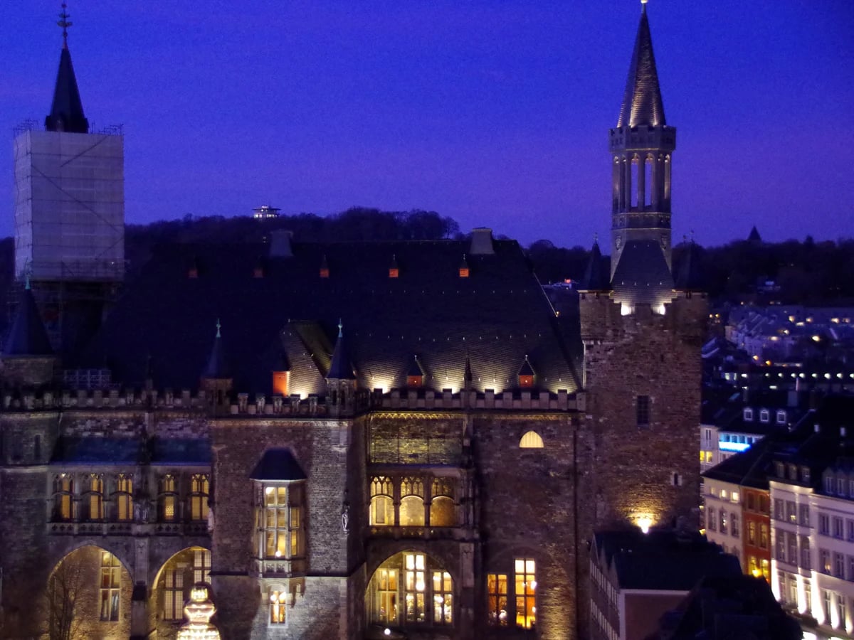 Aachen Rathaus and Cathedral illuminated at twilight during Christmas season