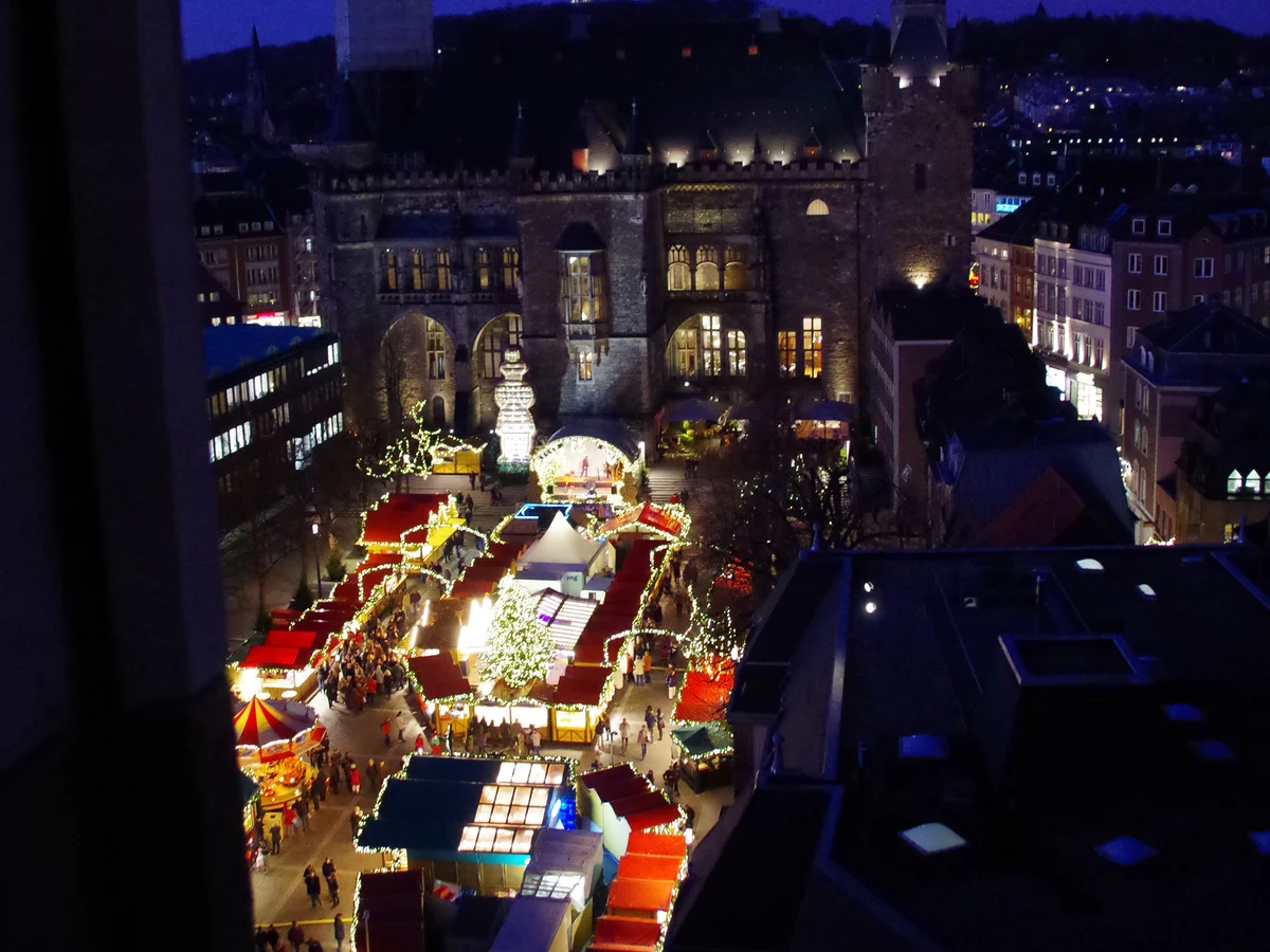 Aachen Cathedral and Town Hall illuminated at twilight during Aachen Christmas market