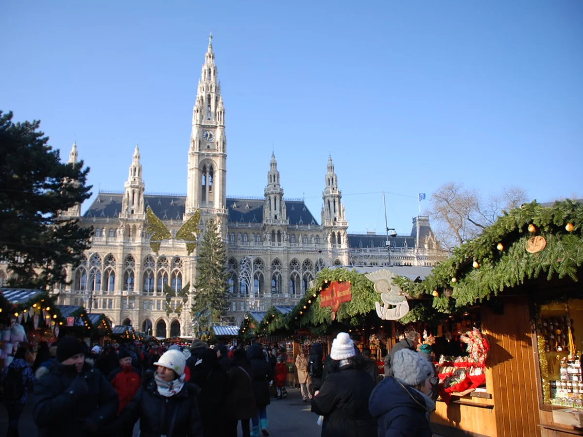 Augsburger Christkindlesmarkt bustling with crowds at Rathausplatz, featuring the iconic Augsburg City Hall.