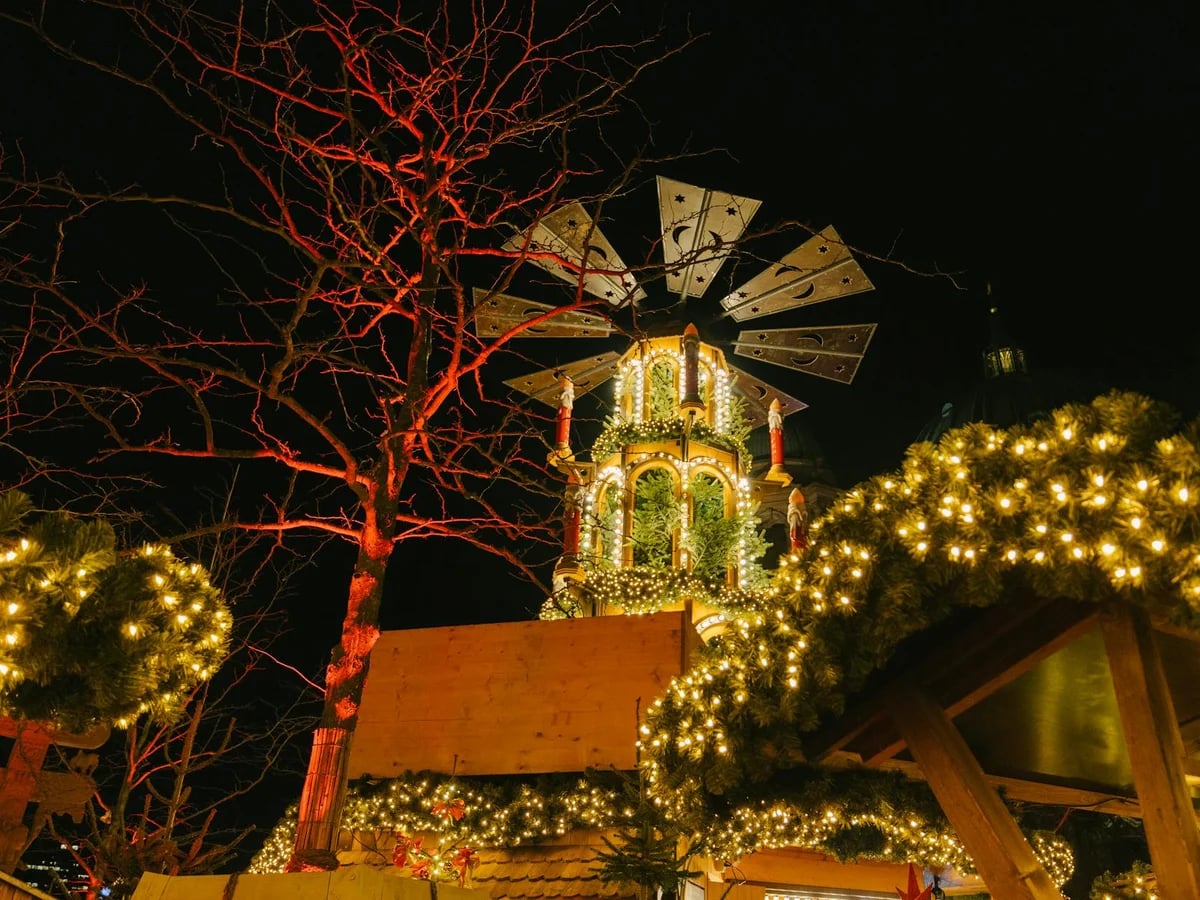 Berlin Christmas market carousel glowing in winter lights