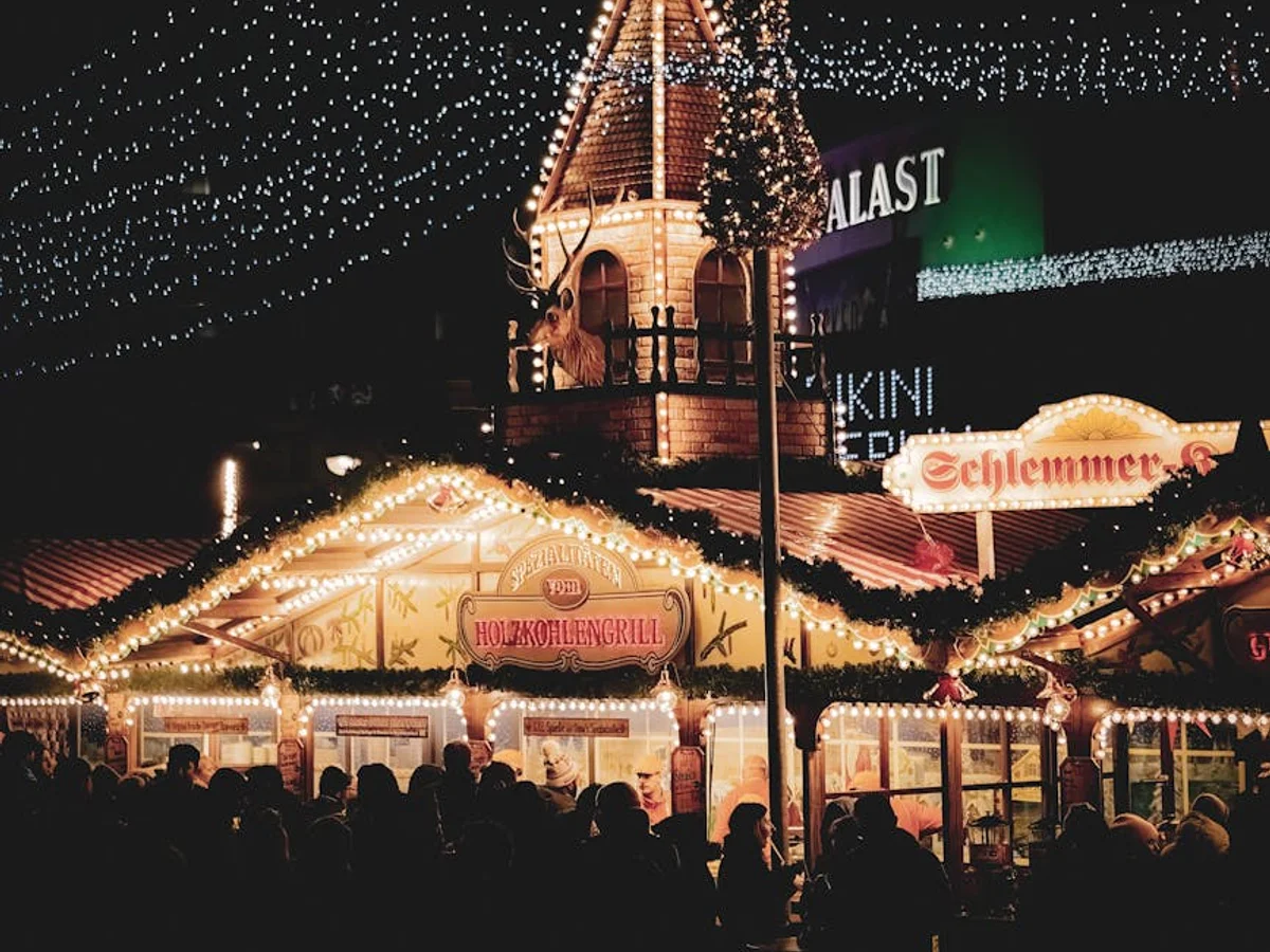 Berlin Christmas market chapel tower glowing warmly at blue hour