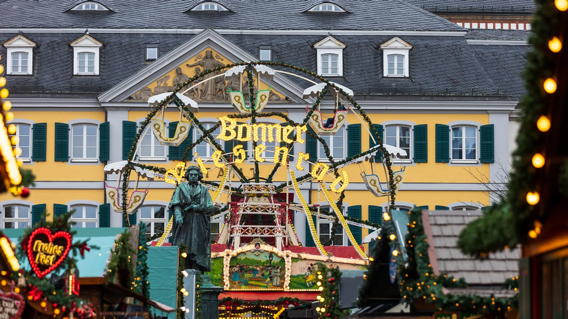 Bonner Weihnachtsmarkt - Münsterplatz glowing at golden hour in Bonn with iconic Beethoven monument and festive stalls