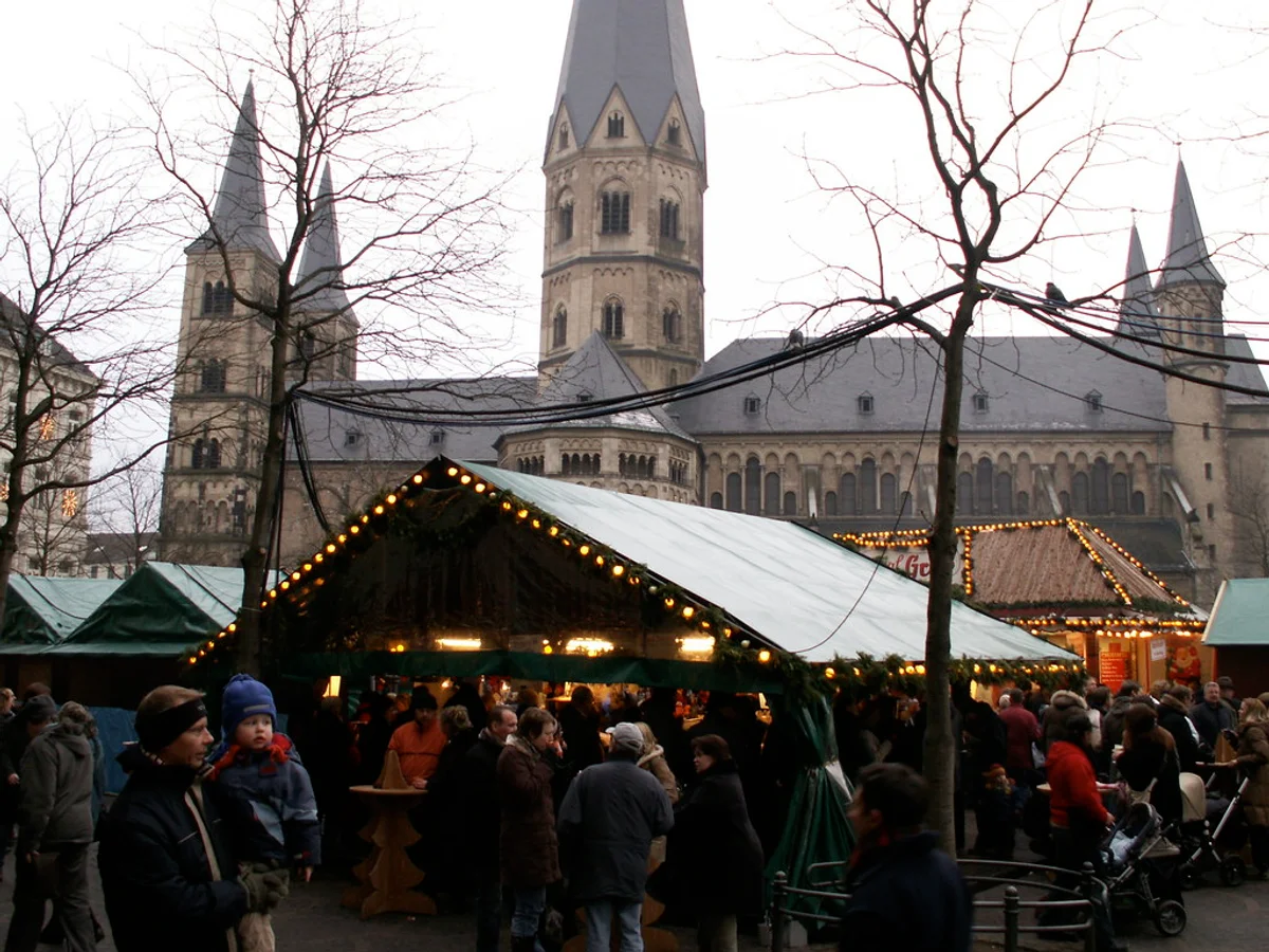 Bonner Weihnachtsmarkt - Münsterplatz festive scene in Bonn with Bonn Minster backdrop