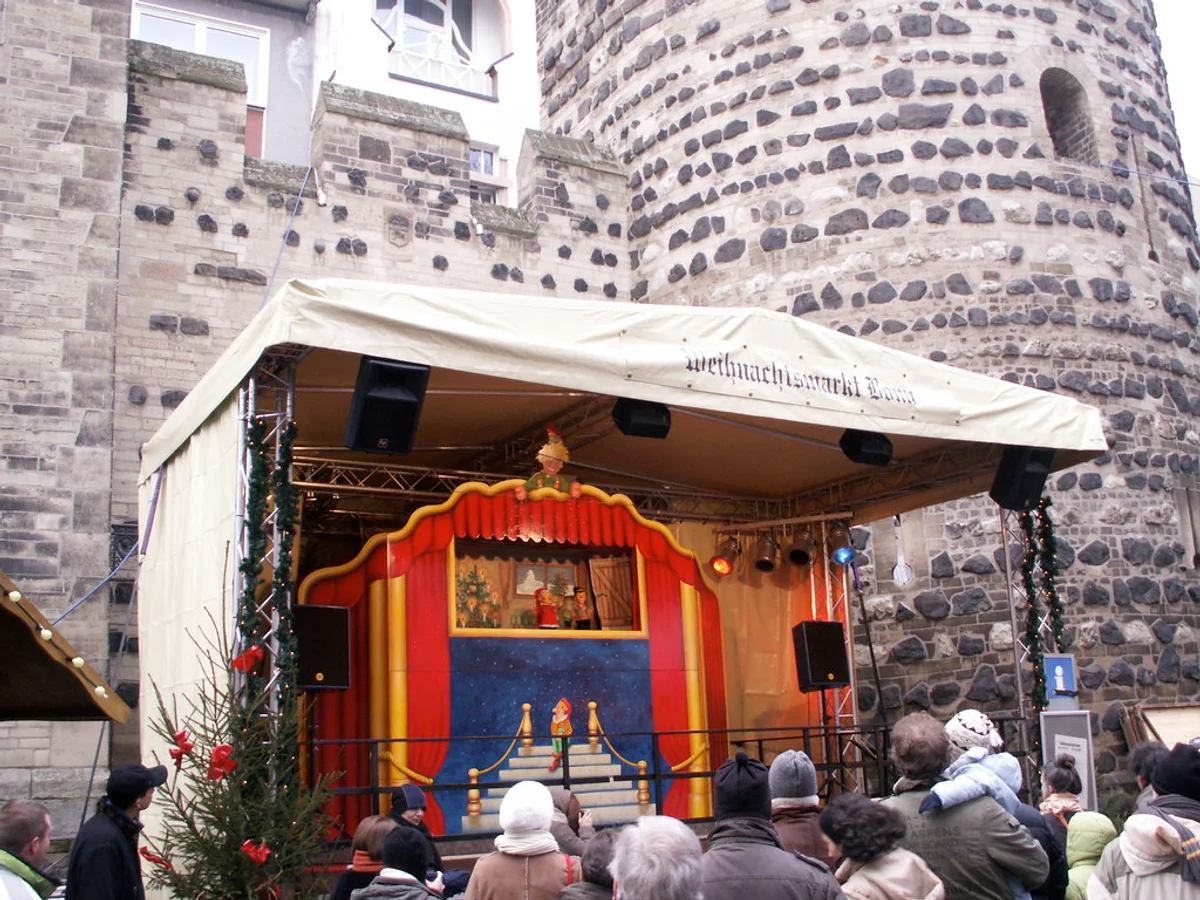Bonner Weihnachtsmarkt puppet theater crowd Bonn festive atmosphere St. Remigius Church