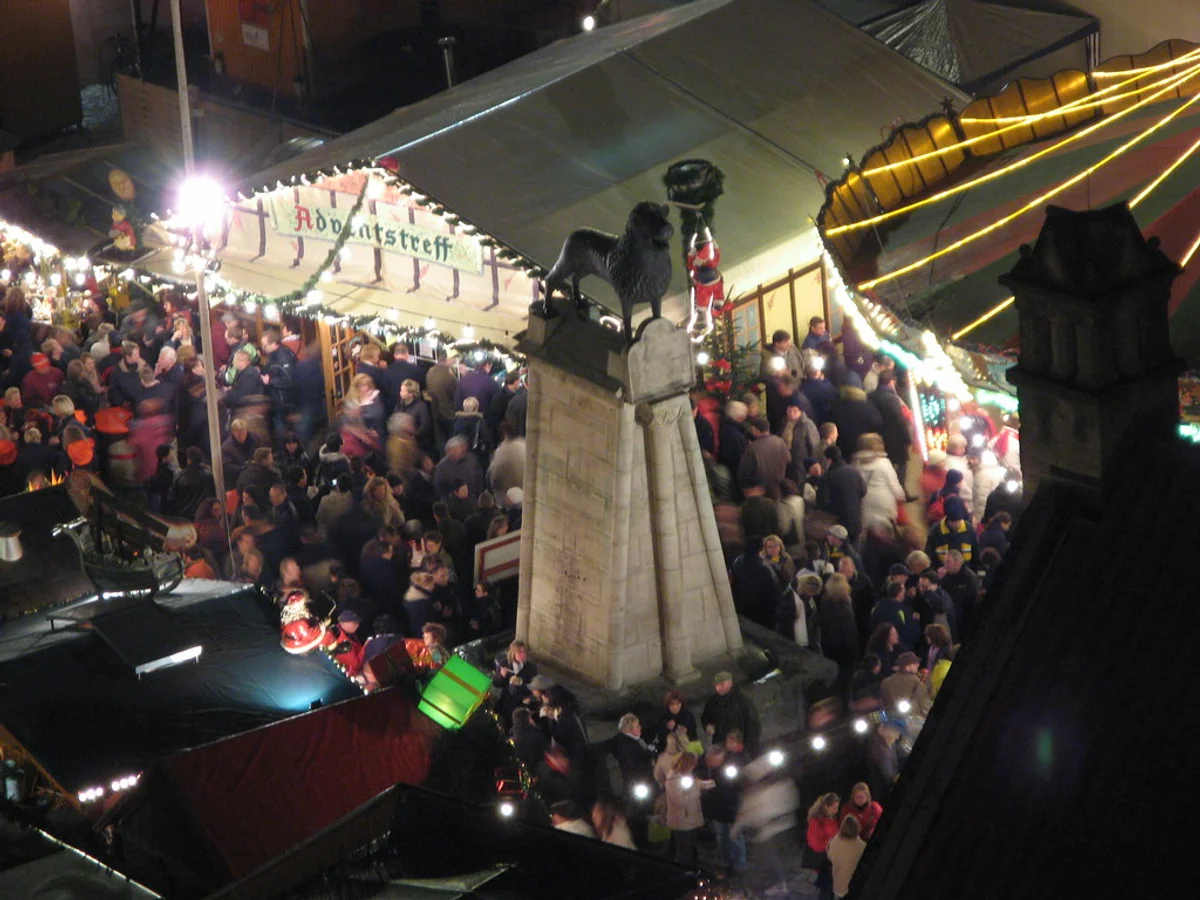 Braunschweiger Weihnachtsmarkt vibrant atmosphere Braunschweig at Burgplatz with Henry the Lion Monument