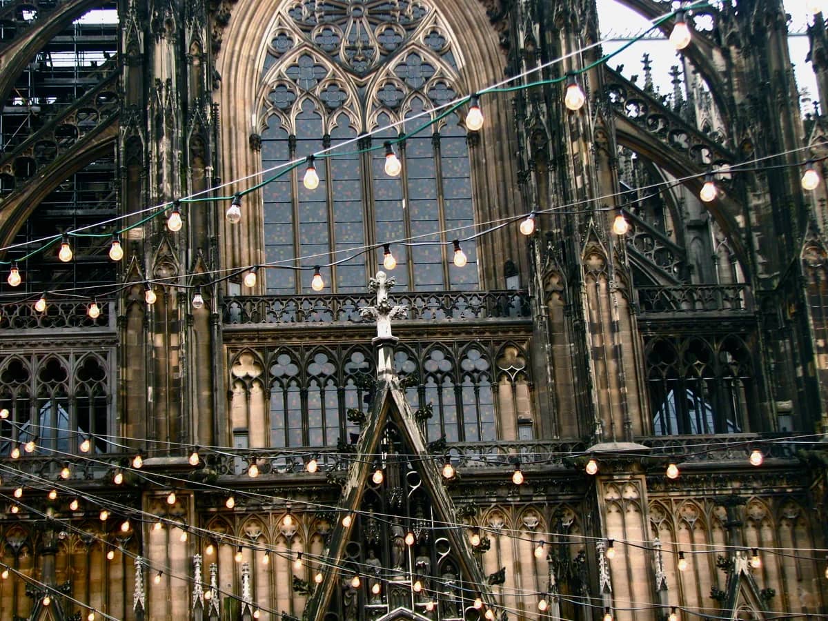 Cologne Cathedral framed by festive string lights in winter