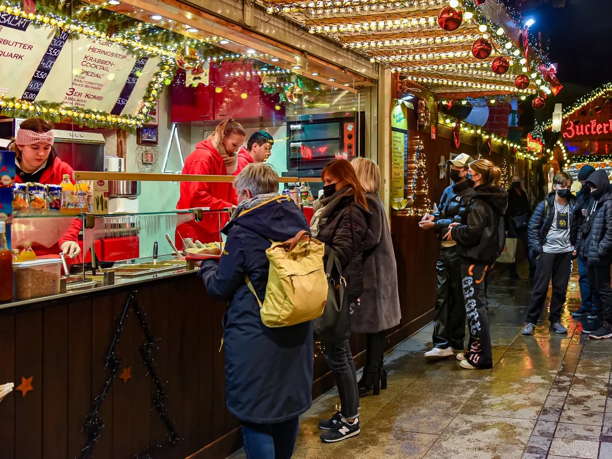 Dortmund bustling Christmas market scene with festive lights and visitors