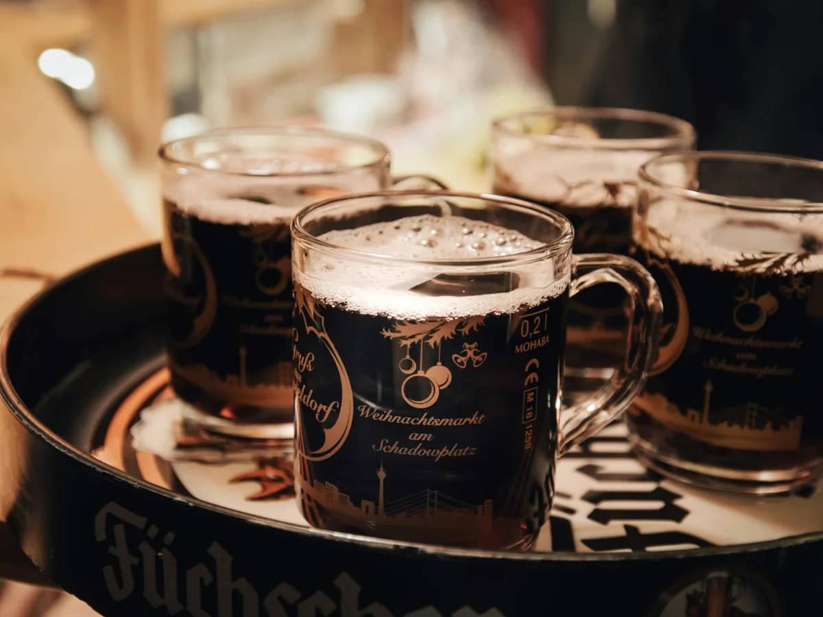 Düsseldorf closeup of Schadowplatz Christmas market mugs filled with mulled wine