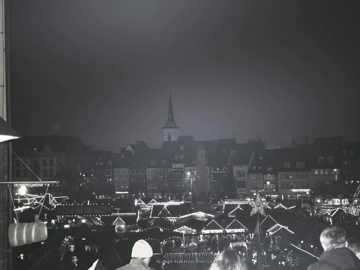 Erfurter Weihnachtsmarkt illuminated stalls Erfurt twilight historic church spire