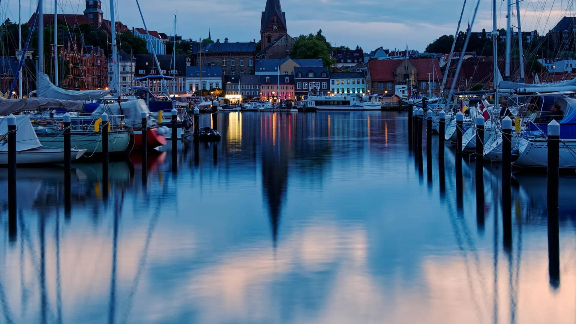 Flensburg harbor illuminated at blue hour during winter season