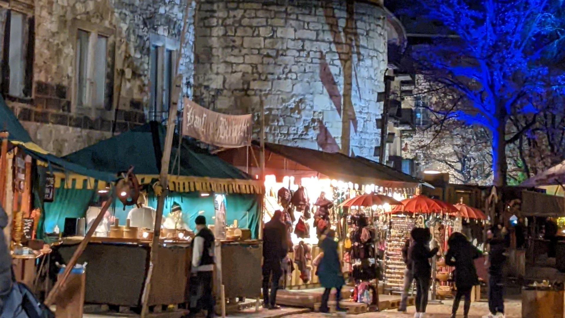 Weihnachtsmarkt Hannover - Holzmarkt illuminated at night with festive atmosphere and historic tower