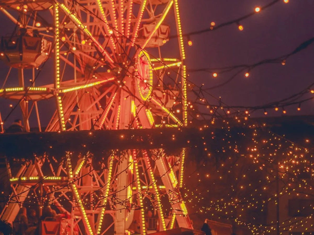 Kassel Ferris wheel illuminated in golden lights during Christmas season