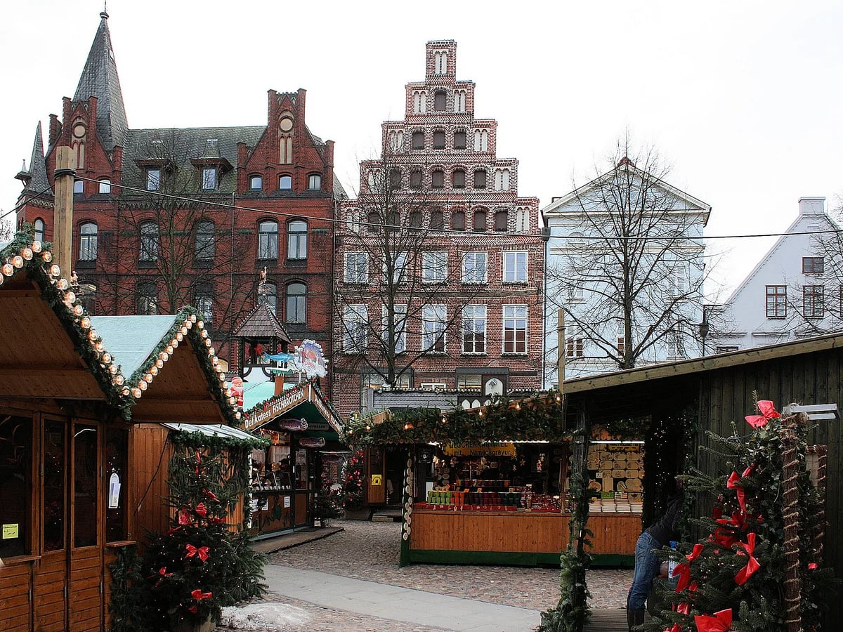 TO HUUS Weihnachtsmarkt wooden stalls garland Lüneburg festive atmosphere Gothic architecture