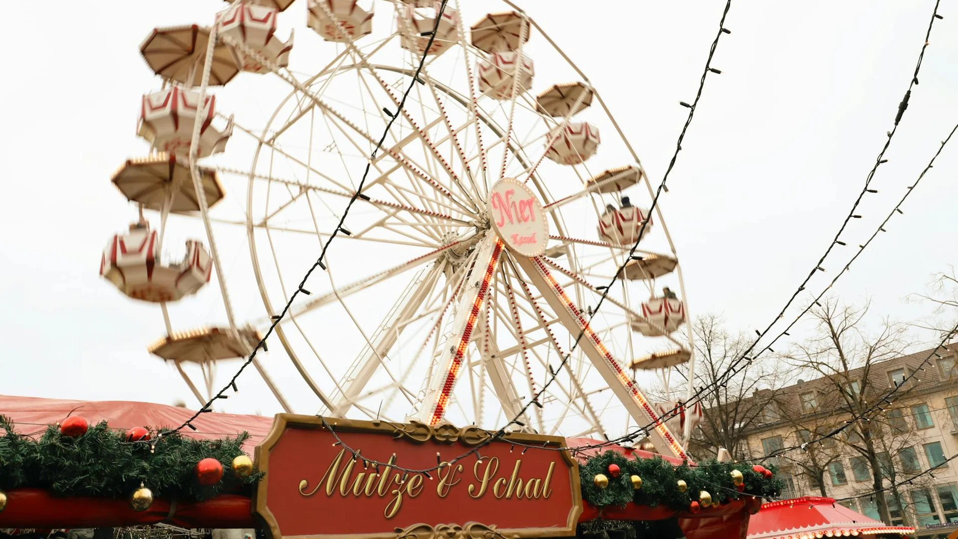 Mainz vintage ferris wheel adorned with festive garland during winter